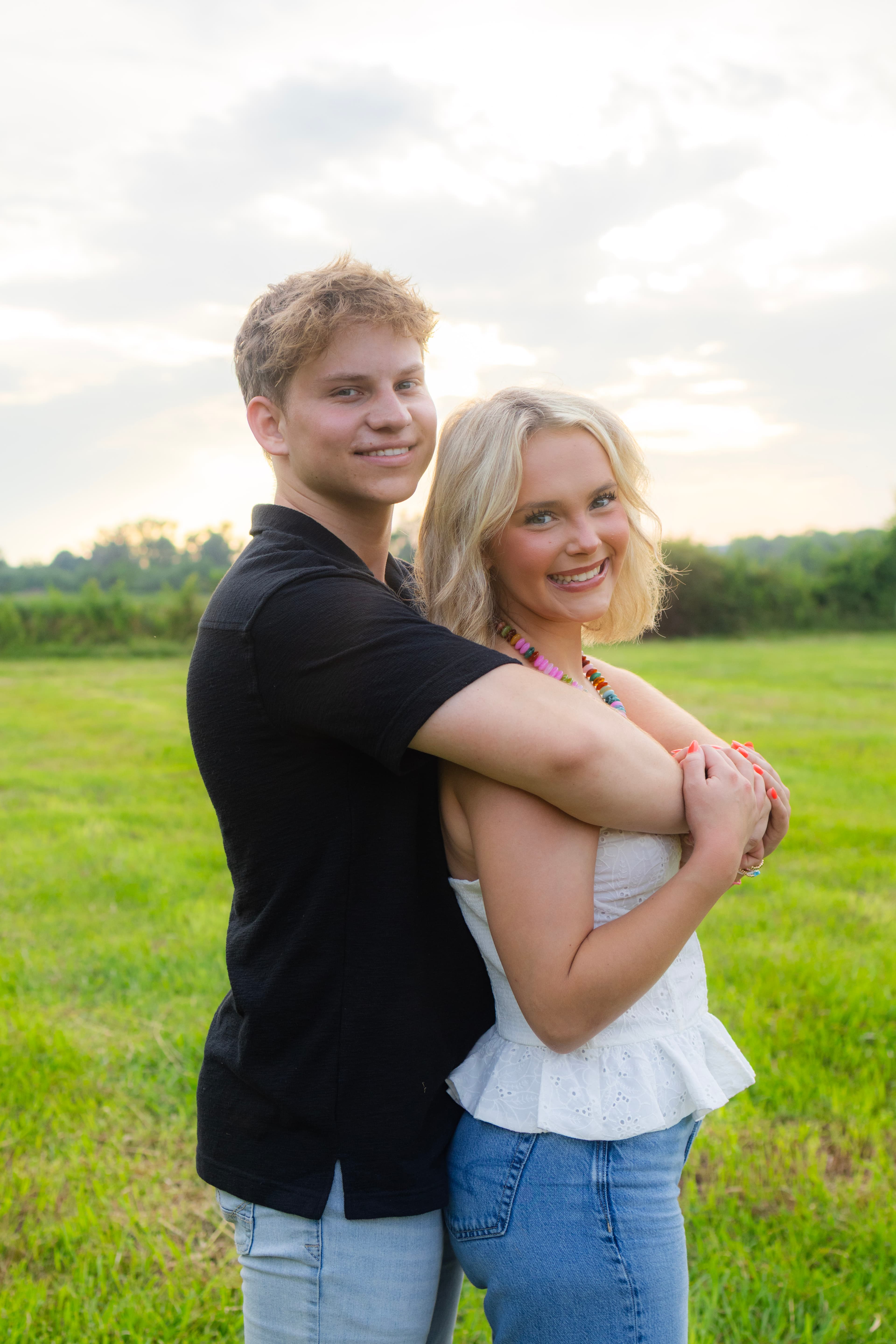 Couple standing together outdoors in soft natural light